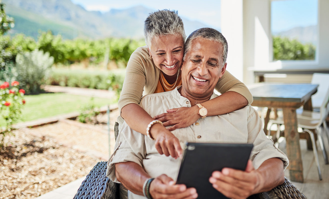 Impacting eyecare in a positive and sustainable way FAQ image of older couple smiling at tablet